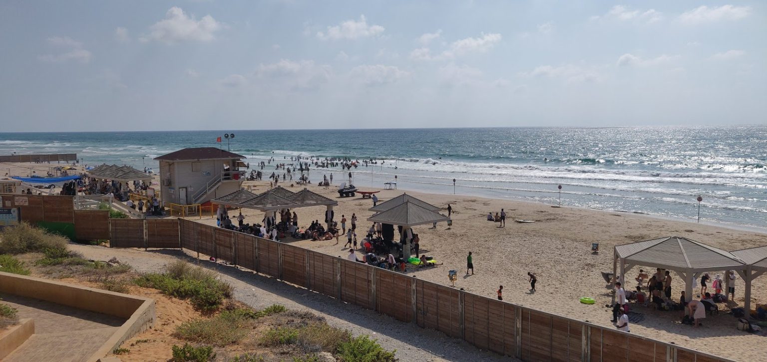 Kiryat Sanz Beach on a sunny day – beachgoers, lifeguard station and Mediterranean Sea